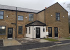 New-build brick terrace with dark roofs